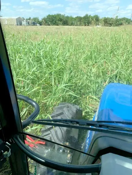 Mowing large acreage from the cab of a tractor